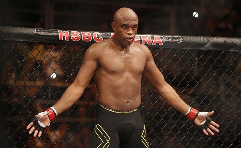 Anderson Silva standing with arms spread inside the cage during a UFC bout