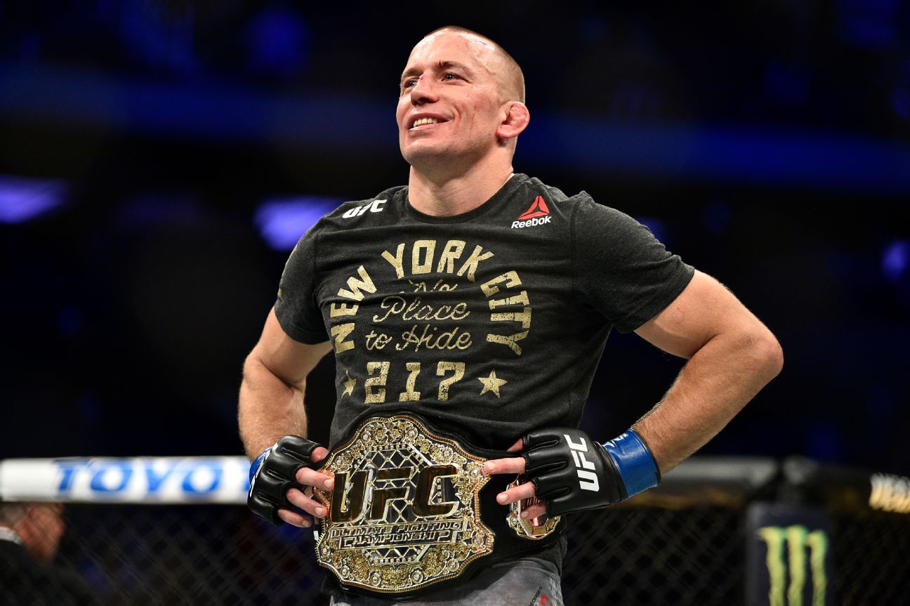 Georges St-Pierre smiling with the UFC championship belt around his waist